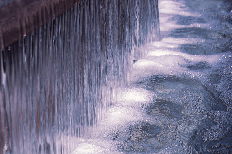 Part of the beautiful and big water fountain. Background with flowing water.